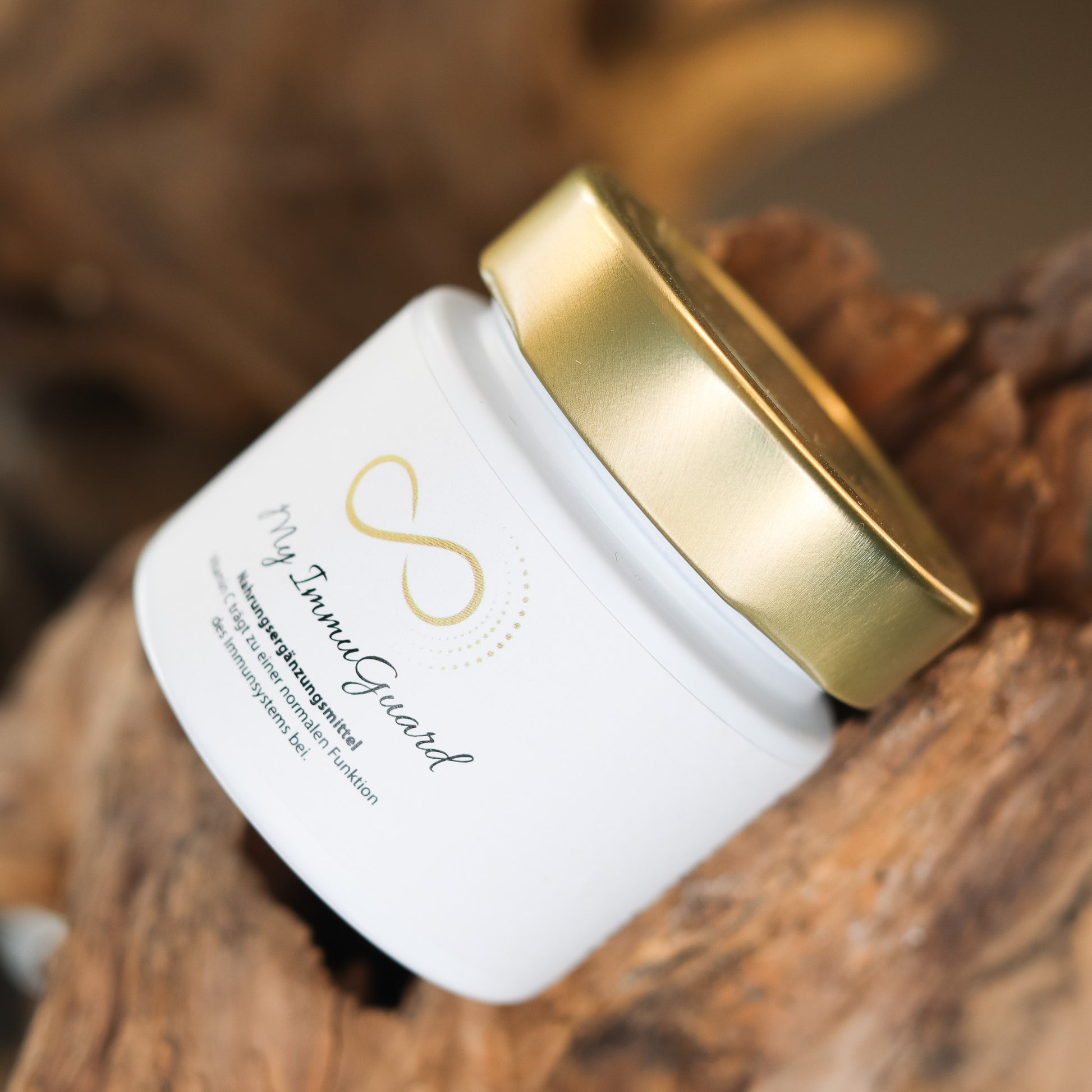 Produktbild eines Nahrungsergänzungsmittels im weißen Glas mit goldenem Deckel, liegend auf natürlichem Holzuntergrund. Abgebildet ist das Produkt „My ImmuGuard“ aus der ANS Nutrivity Secrets Serie – hochwertiges Supplement, fotografiert zur Veranschaulichung der Verpackung. Die genaue Zusammensetzung und Anwendungshinweise sind der Produktbeschreibung im Shop zu entnehmen.