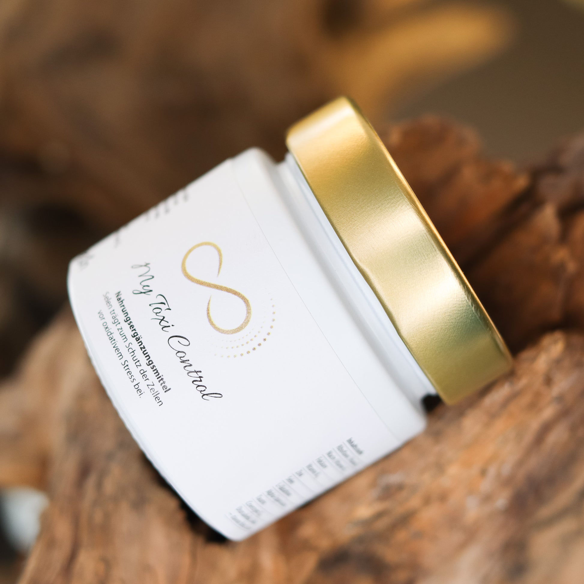 Produktbild eines Nahrungsergänzungsmittels im weißen Glas mit goldenem Deckel, liegend auf natürlichem Holzuntergrund. Abgebildet ist das Produkt „My Toxi Control“ aus der ANS Nutrivity Secrets Serie – hochwertiges Supplement, fotografiert zur Veranschaulichung der Verpackung. Die genaue Zusammensetzung und Anwendungshinweise sind der Produktbeschreibung im Shop zu entnehmen.